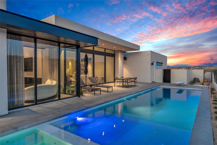 Luxury home with a pool at sunset